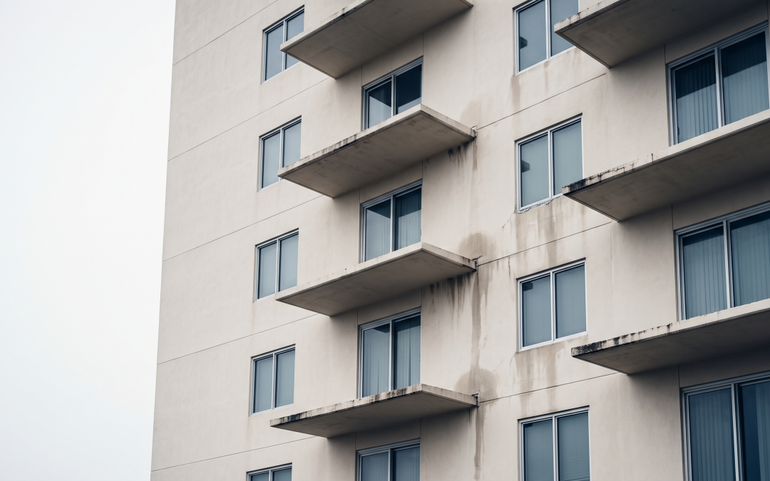 Balconies and exterior wall of a Gulf Coast condominium tower showing water staining and sealant failure